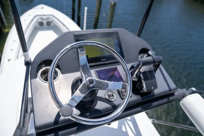 Slide: The Image of Steering console of 2023 Contender 44 CB boat with navigation controls. - 28