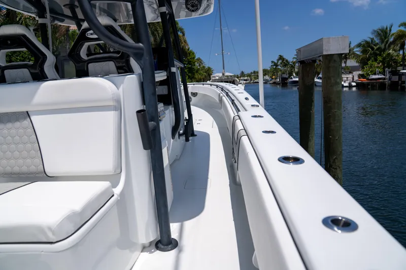 Slide: The Image of 2023 Contender 44 CB boat docked on a sunny day, showcasing sleek design and seating. - 29