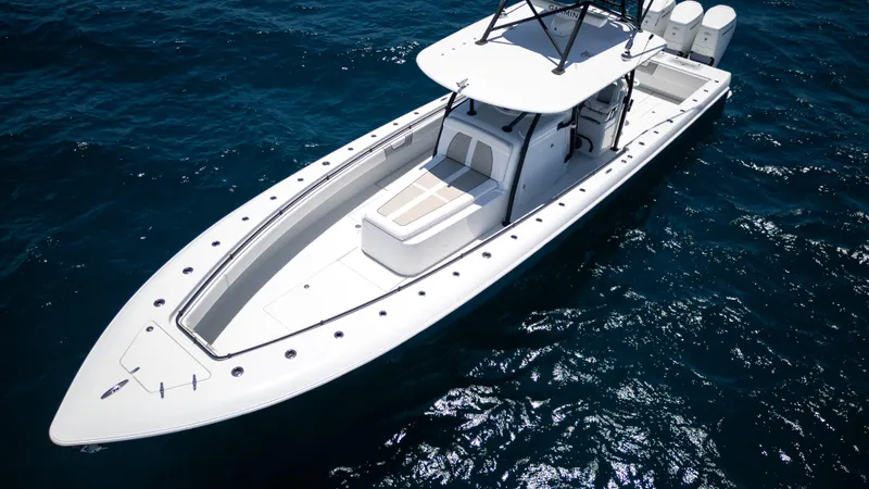 Slide: The Image of 2023 Contender 44 CB boat on open water, showcasing sleek design and powerful engines. - 30