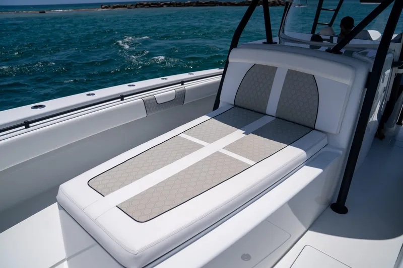 Slide: The Image of 2023 Contender 44 CB boat with cushioned seating, on a sunny day at sea. - 31