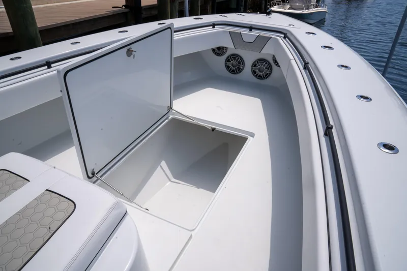 Slide: The Image of 2023 Contender 44 CB boat with open storage compartment and speakers on deck. - 37