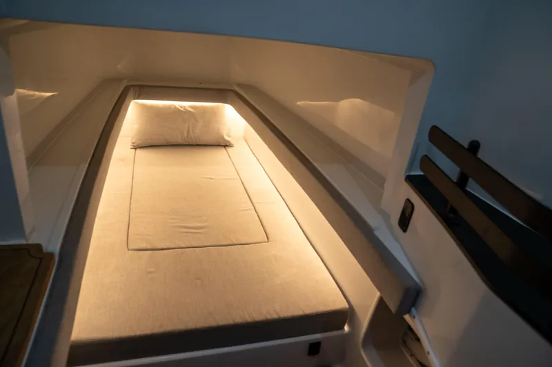 Slide: The Image of 2023 Contender 44 CB cabin interior with cozy bed and ambient lighting. - 38