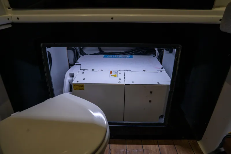 Slide: The Image of 2023 Contender 44 CB boat interior showing a generator compartment and toilet. - 39