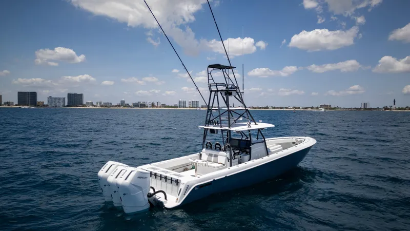 Slide: The Image of 2023 Contender 44 CB boat on open water under a partly cloudy sky. - 4