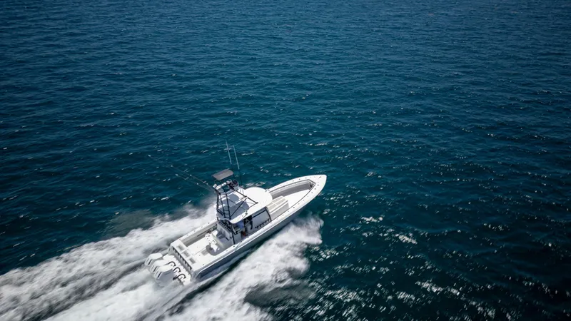 Slide: The Image of 2023 Contender 44 CB boat cruising on open ocean waters. - 43