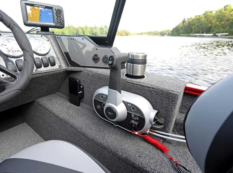 Slide: The Image of 2026 Lund 1650 Angler boat interior with control panel and navigation system. - 7
