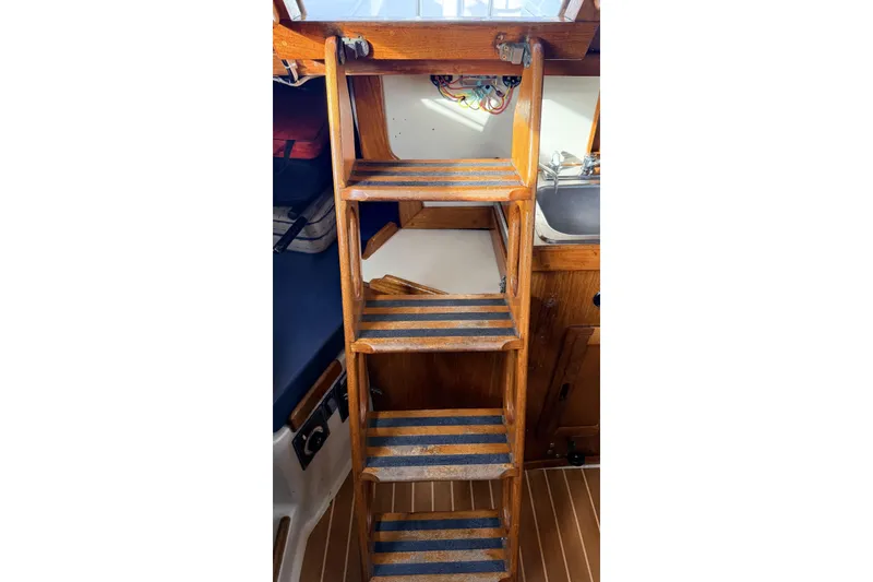 Slide: The Image of Wooden cabin stairs inside 1979 Ericson 30 Plus sailboat, leading to deck. - 17