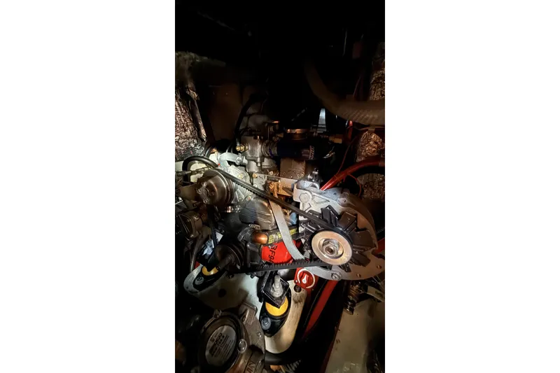 Slide: The Image of Engine compartment of a 1979 Ericson 30 Plus sailboat, showcasing mechanical components. - 18