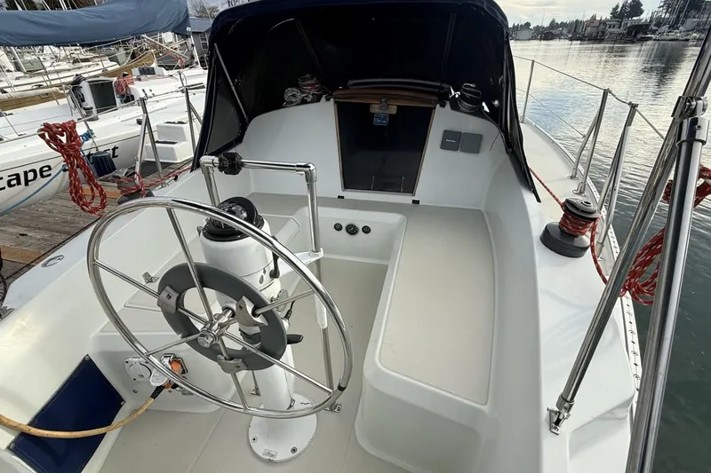 Slide: The Image of 1979 Ericson 30 Plus sailboat cockpit with steering wheel, docked at marina. - 25