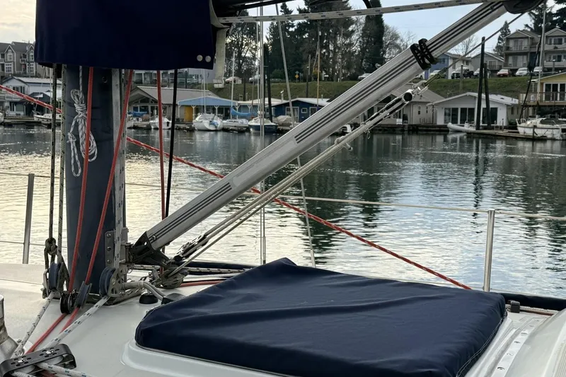 Slide: The Image of 1979 Ericson 30 Plus sailboat docked in a marina, featuring rigging and calm waters. - 29