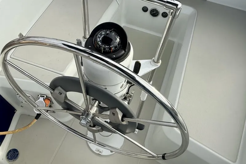 Slide: The Image of Steering wheel and compass of a 1979 Ericson 30 Plus sailboat. - 31