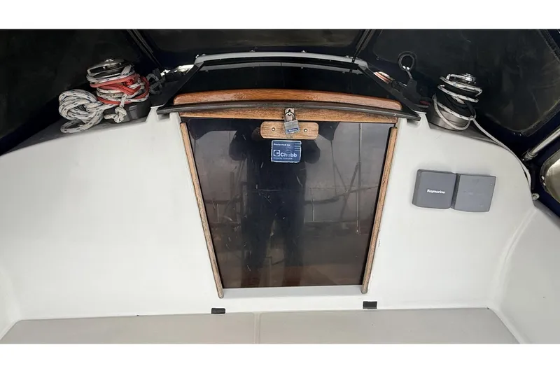 Slide: The Image of 1979 Ericson 30 Plus sailboat cockpit with ropes, winches, and Raymarine equipment. - 33
