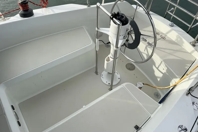 Slide: The Image of Cockpit of 1979 Ericson 30 Plus sailboat with steering wheel and clean seating area. - 35