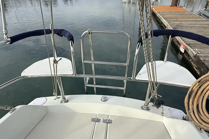 Slide: The Image of 1979 Ericson 30 Plus sailboat stern view with dock in background. - 38