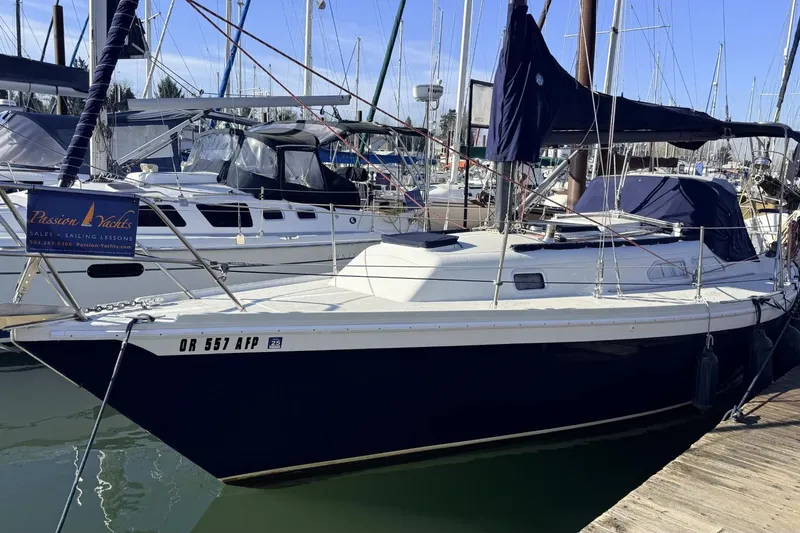 Slide: The Image of 1979 Ericson 30 Plus sailboat docked at marina, featuring sleek design and blue hull. - 42
