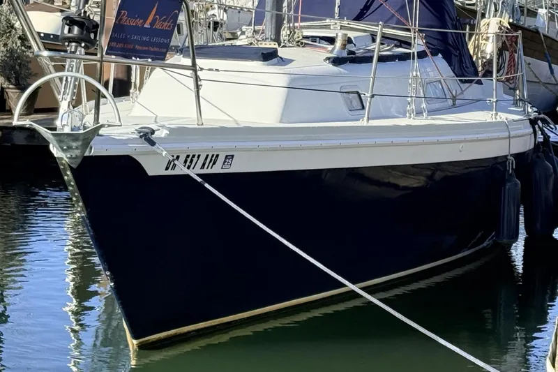 Slide: The Image of 1979 Ericson 30 Plus sailboat docked in marina, featuring sleek design and sturdy build. - 43