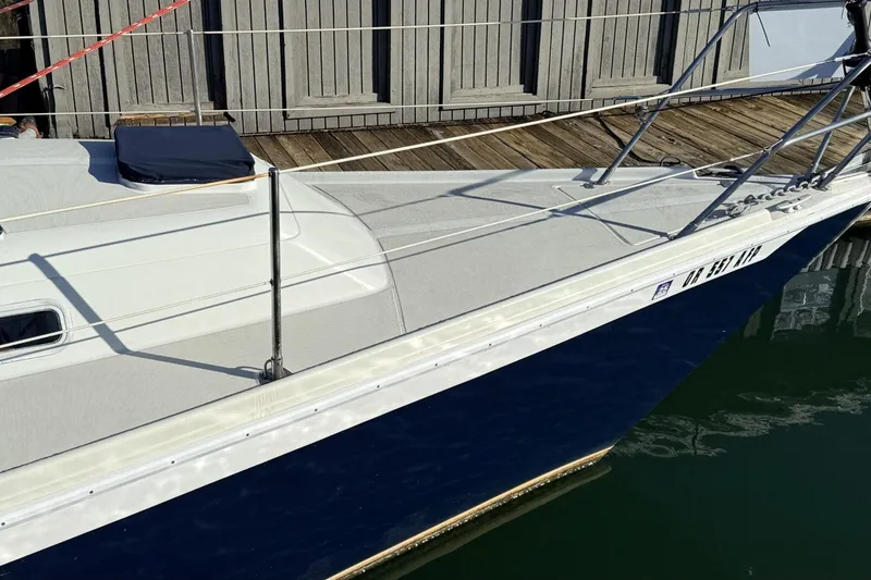 Slide: The Image of 1979 Ericson 30 Plus sailboat docked, featuring sleek white and blue design. - 45