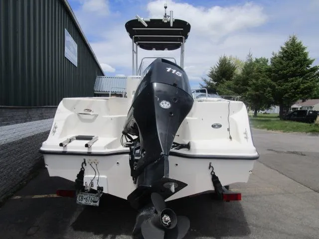 Slide: The Image of 2002 Trophy 1903 CC boat with outboard motor, parked outdoors. - 5
