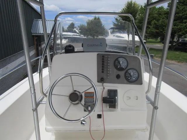 Slide: The Image of Center console of 2002 Trophy 1903 CC boat with steering wheel and Garmin device. - 6