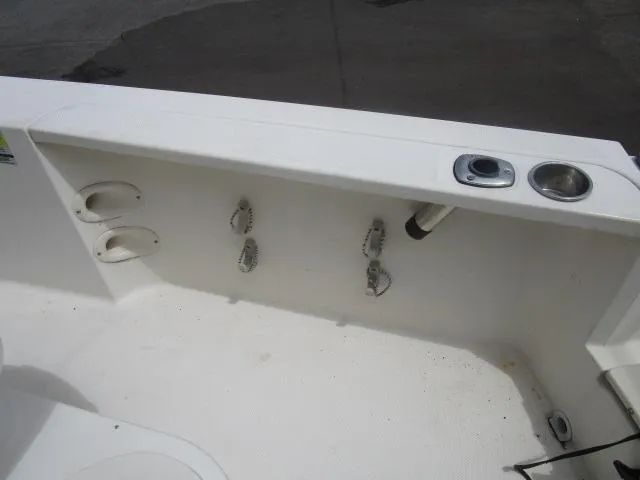 Slide: The Image of Interior view of a 2002 Trophy 1903 CC boat, featuring rod holders and cup holder. - 8