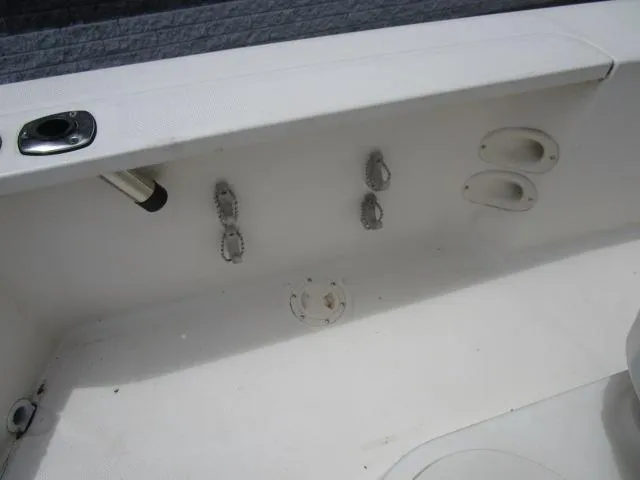 Slide: The Image of Interior view of a 2002 Trophy 1903 CC boat, featuring rod holders and storage compartments. - 9