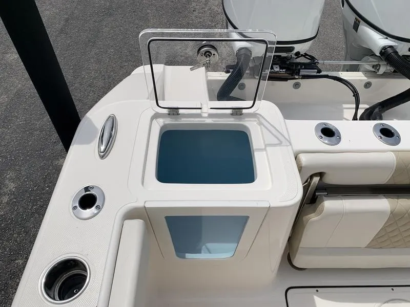 Slide: The Image of 2024 Bulls Bay 255CC boat with open storage compartment and fishing rod holders. - 10