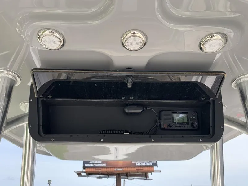 Slide: The Image of 2024 Bulls Bay 255CC boat console with storage and electronic equipment. - 13