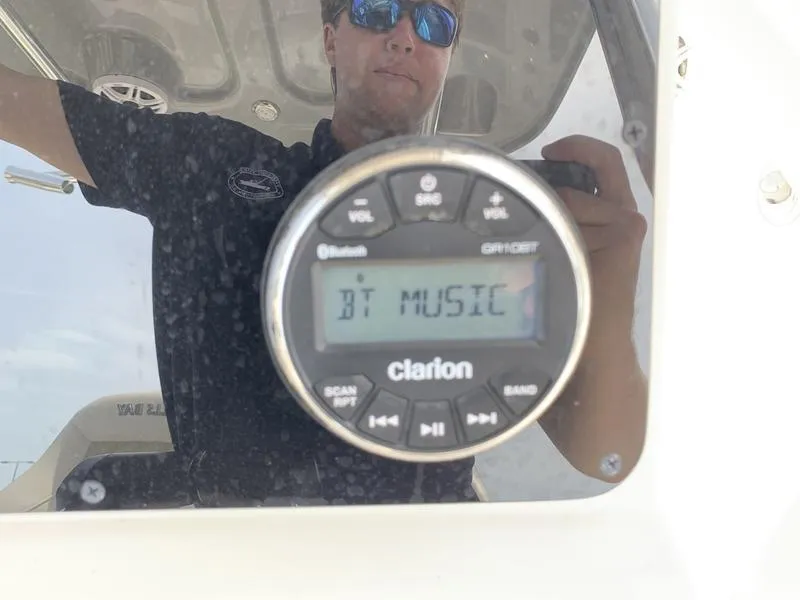 Slide: The Image of 2024 Bulls Bay 255CC boat with Clarion audio system displaying "BT Music." - 19