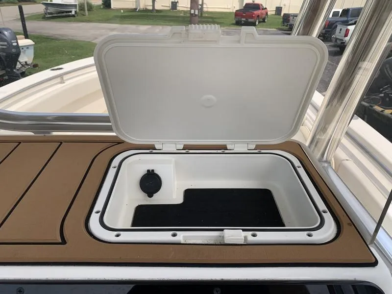 Slide: The Image of 2024 Bulls Bay 255CC boat storage compartment with open lid, showcasing interior space. - 20