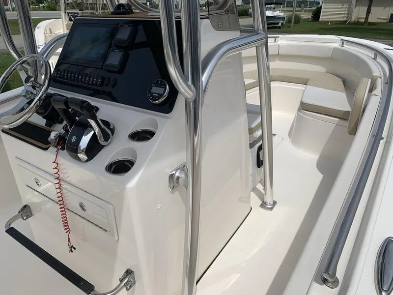 Slide: The Image of 2024 Bulls Bay 255CC boat interior with console, steering wheel, and seating area. - 21