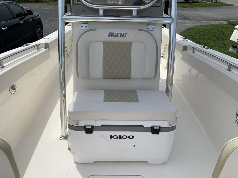 Slide: The Image of 2024 Bulls Bay 255CC boat interior with Igloo cooler and cushioned seating. - 24