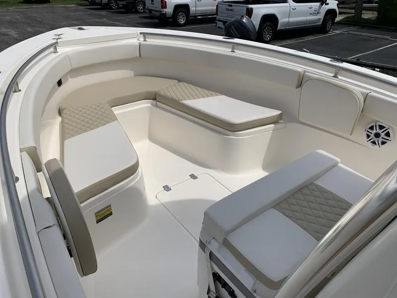 Slide: The Image of 2024 Bulls Bay 255CC boat interior with cushioned seating and storage compartments. - 26