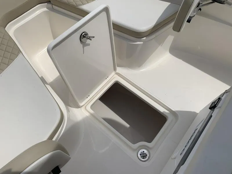 Slide: The Image of 2024 Bulls Bay 255CC boat storage compartment with open hatch and seating area. - 27