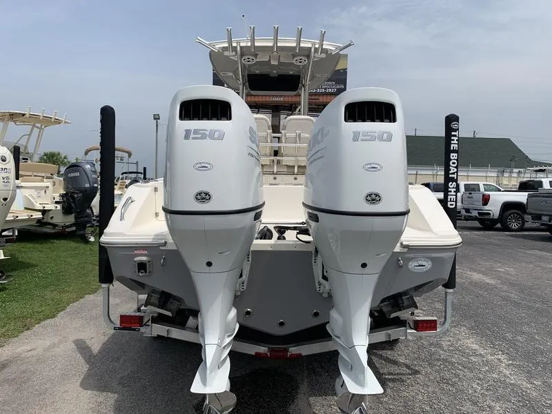 Slide: The Image of 2024 Bulls Bay 255CC boat with dual 150 horsepower engines, displayed at a dealership. - 3