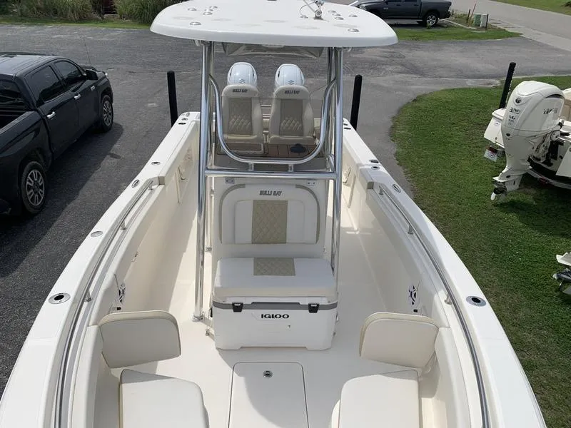 Slide: The Image of 2024 Bulls Bay 255CC boat with center console and seating, parked on a driveway. - 30