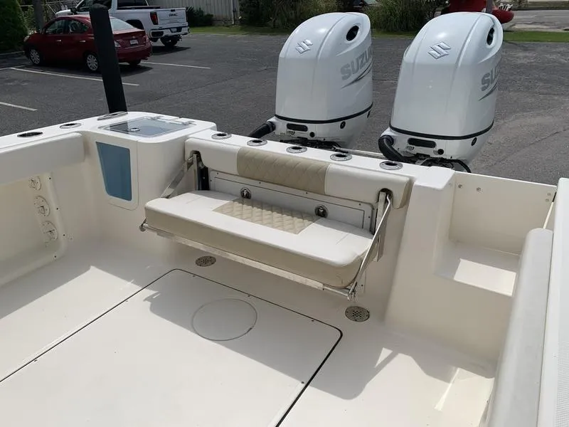 Slide: The Image of 2024 Bulls Bay 255CC boat with dual Suzuki outboard motors and foldable seating. - 8