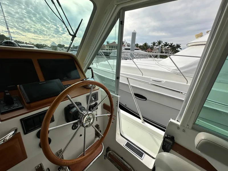 Slide: The Image of Interior view of 2020 Back Cove 41 yacht helm with steering wheel and controls. - 10