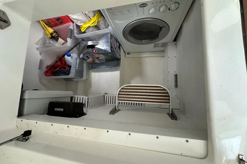 Slide: The Image of Laundry area with washer and storage on 2020 Back Cove 41 boat. - 13