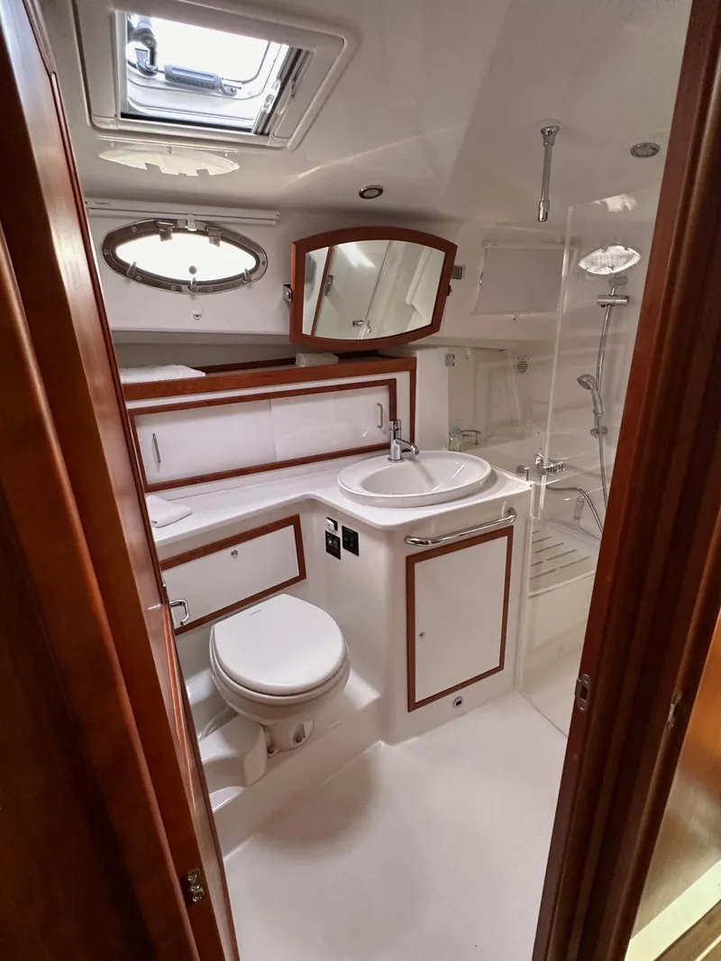 Slide: The Image of 2020 Back Cove 41 yacht bathroom with modern fixtures and wood accents. - 16