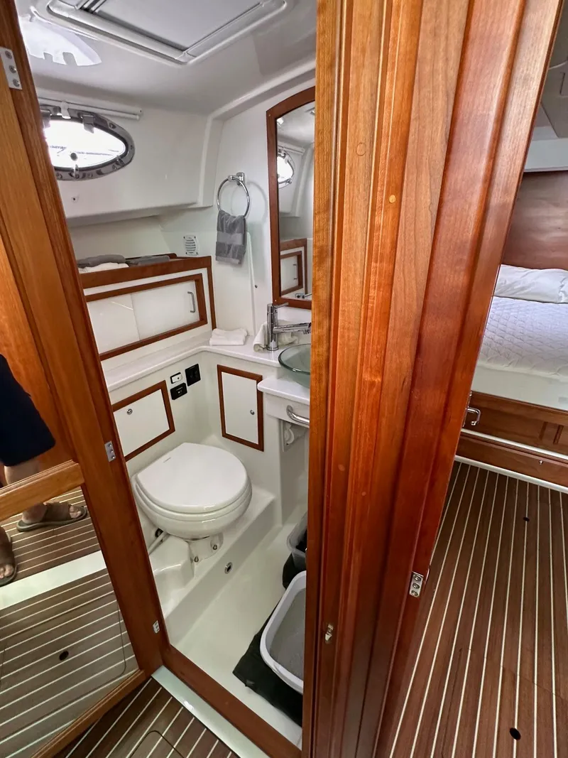 Slide: The Image of 2020 Back Cove 41 yacht interior with wooden finishes and compact bathroom. - 17