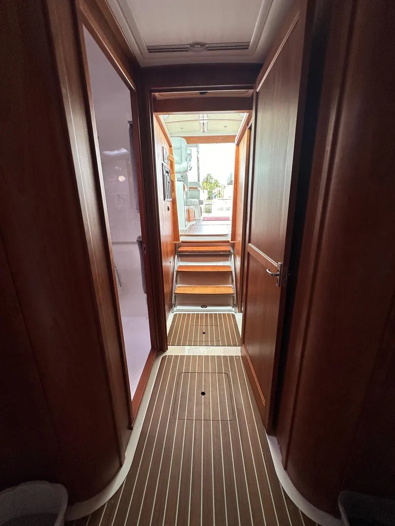 Slide: The Image of Interior hallway of 2020 Back Cove 41 yacht with wooden flooring and steps. - 19