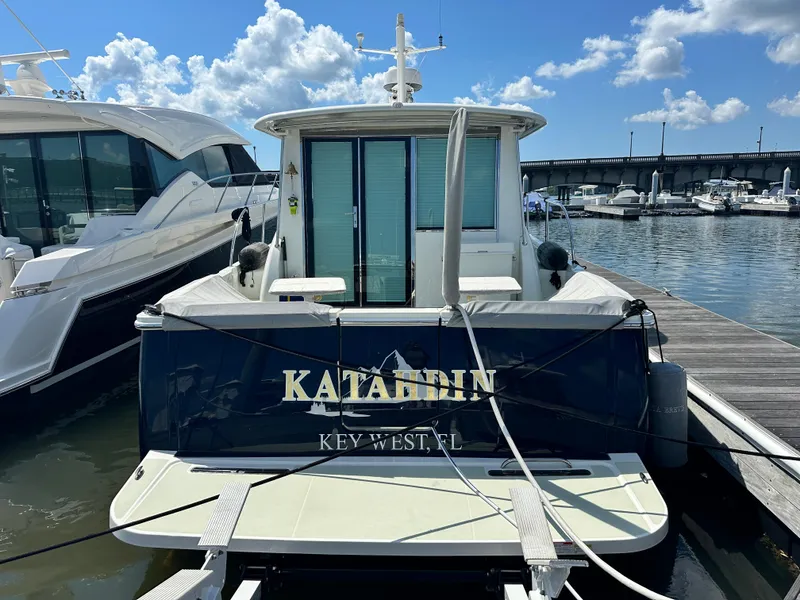 Slide: The Image of Back Cove 41 yacht, 2020 model, docked at marina under blue sky. - 2