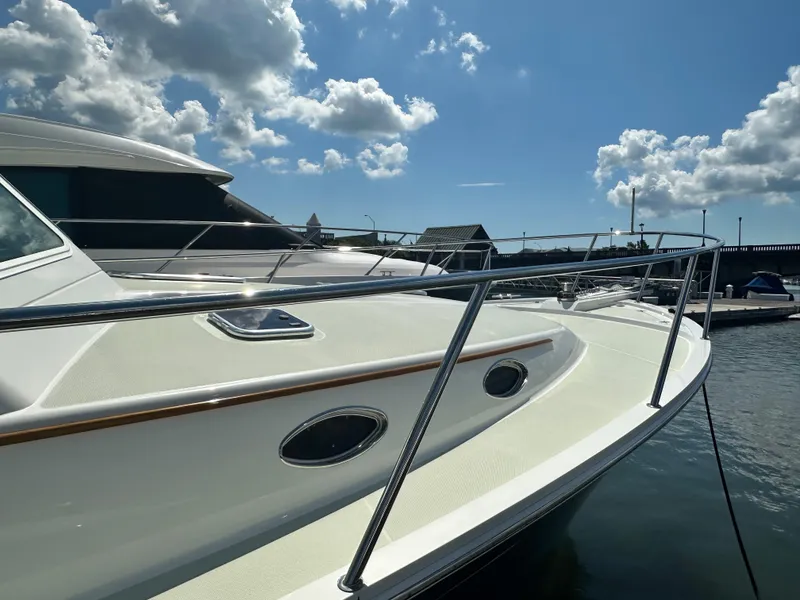 Slide: The Image of 2020 Back Cove 41 yacht docked under a bright blue sky with clouds. - 23