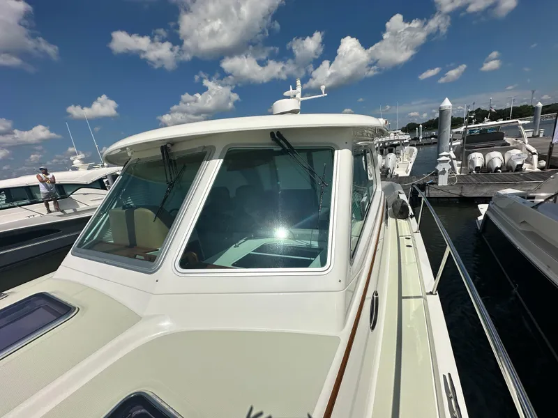 Slide: The Image of 2020 Back Cove 41 yacht docked under a partly cloudy sky. - 42