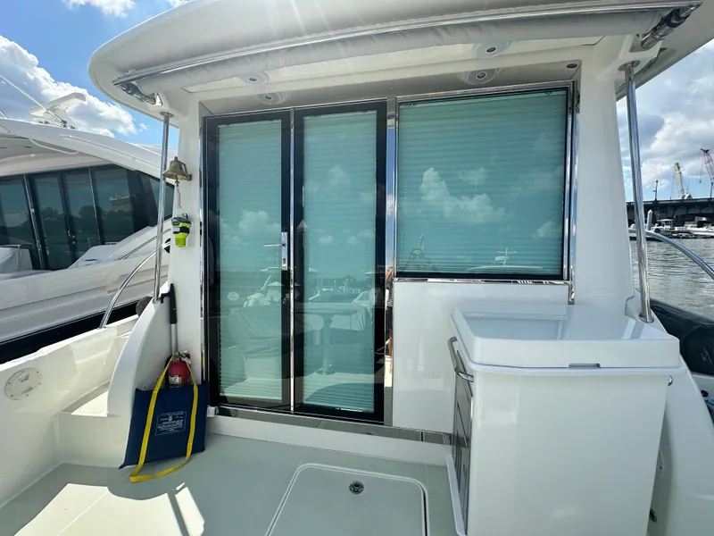 Slide: The Image of 2020 Back Cove 41 yacht with sliding glass doors and outdoor seating area. - 48