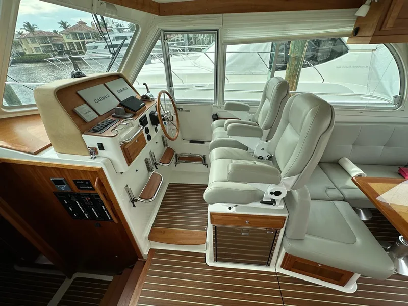 Slide: The Image of 2020 Back Cove 41 yacht interior with leather seats and wooden accents. - 8