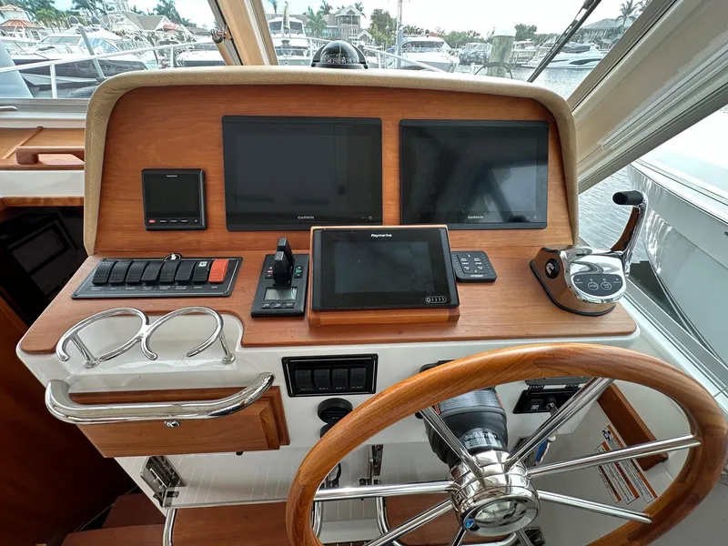 Slide: The Image of Helm of 2020 Back Cove 41 yacht with navigation screens and controls. - 9