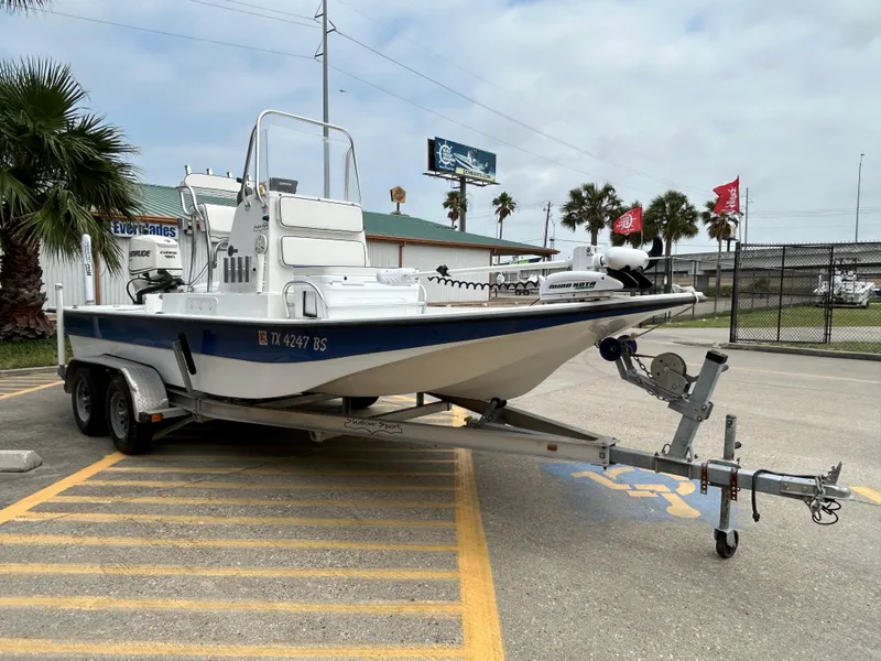 Slide: The Image of 2012 Shallow Sport 21 Sport boat on trailer in parking lot. - 2