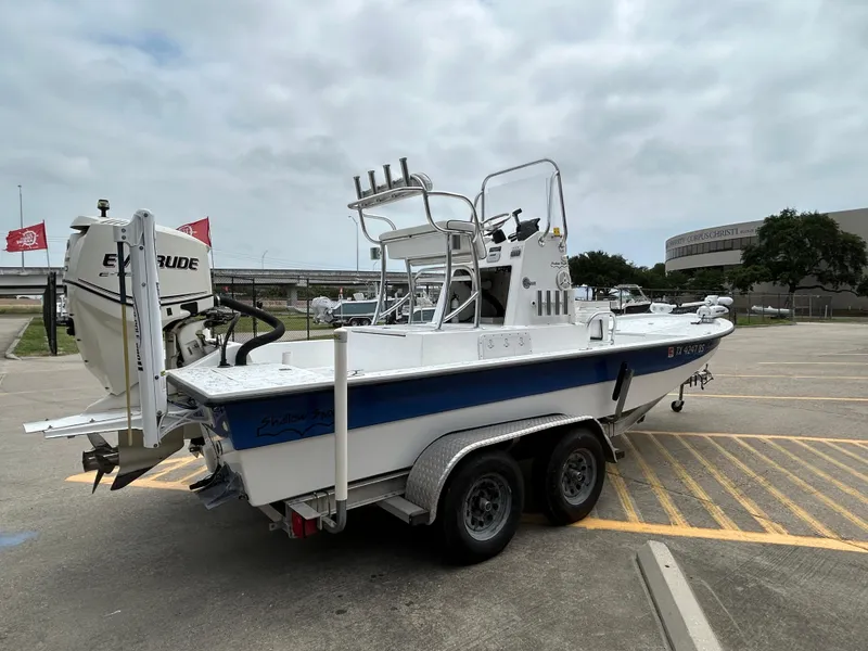 Slide: The Image of 2012 Shallow Sport 21 Sport boat on trailer in parking lot. - 4