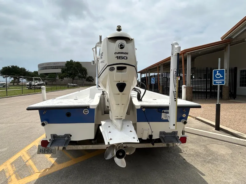 Slide: The Image of 2012 Shallow Sport 21 Sport boat with Evinrude 150 engine, parked in a lot. - 5